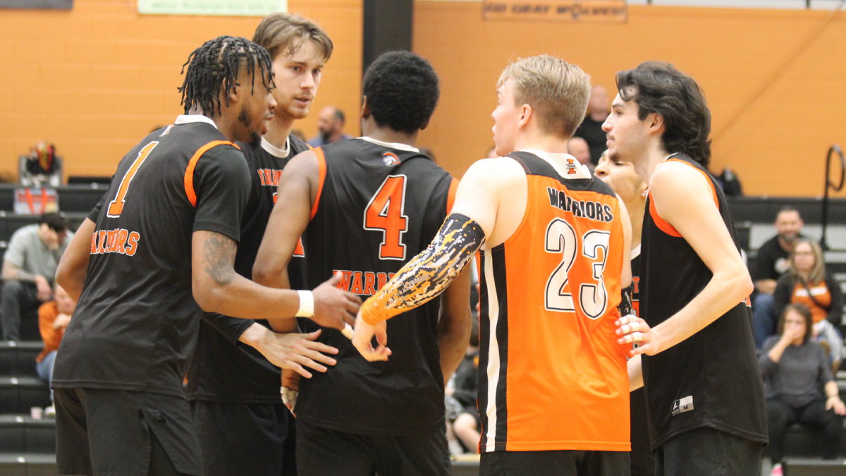Indiana Tech men's volleyball players huddle during the last match of the regular season.